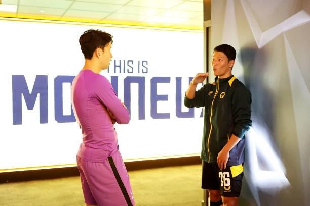 Hee-chan Hwang of Wolverhampton Wanderers speaks with Son Heung-Min of Tottenham Hotspur in the tunnel following the Carabao Cup Third Round match...