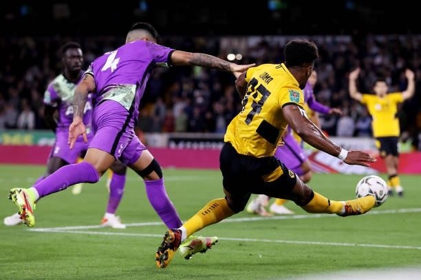 Adama Traore of Wolverhampton Wanderers crosses the ball under pressure from Cristian Romero of Tottenham Hotspur during the Carabao Cup Third Round...