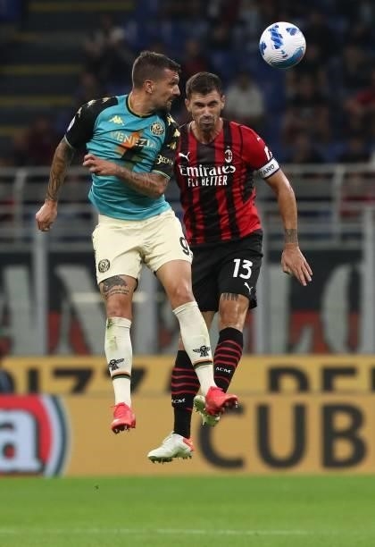 Francesco Forte of Venezia FC and Alessio Romagnoli of AC Milan jump for the ball during the Serie A match between AC Milan and Venezia FC at Stadio...