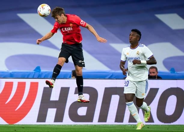Vinicius Junior of Real Madrid CF battle for the ball with Aleix Febas of RDC Mallorca during the La Liga Santander match between Real Madrid CF and...