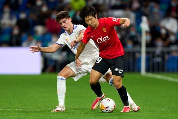 Miguel Gutierrez of Real Madrid CF battle for the ball with Kang-in Lee of RDC Mallorca during the La Liga Santander match between Real Madrid CF and...