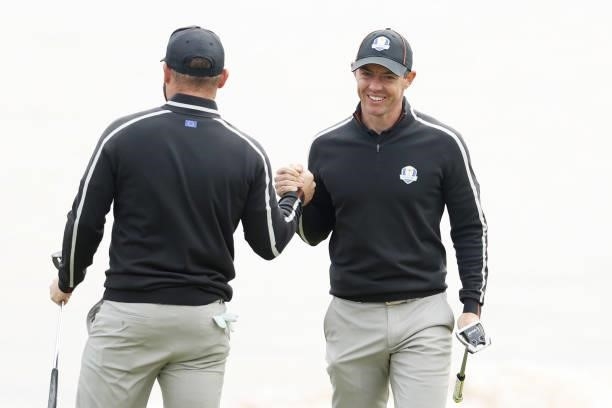 Tyrrell Hatton of England and team Europe and Rory McIlroy of Northern Ireland and team Europe celebrate during practice rounds prior to the 43rd...