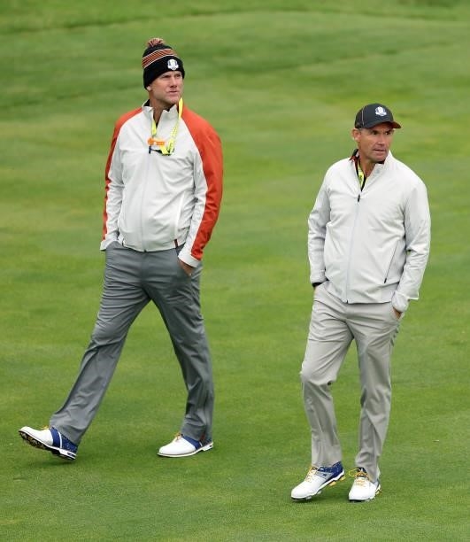 Vice-captain Robert Karlsson of Sweden and team Europe and captain Padraig Harrington of Ireland and team Europe walk across the course during...
