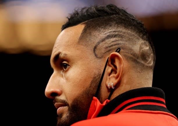 Nick Kyrgios of Team World shows off his hair cut with a tennis ball in it from the sidelines during Day 1 of the 2021 Laver Cup at TD Garden on...
