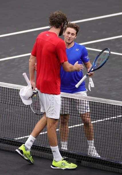 Reilly Opelka of Team World shakes hands with Casper Ruud of Team Europe after the first match during Day 1 of the 2021 Laver Cup at TD Garden on...