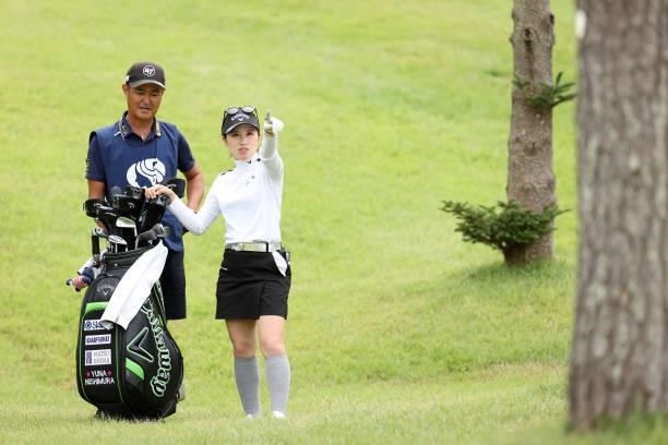 Yuna Nishimura of Japan talks with her caddie before her second shot on the 8th hole during the second round of the Miyagi TV Cup Dunlop Ladies Open...