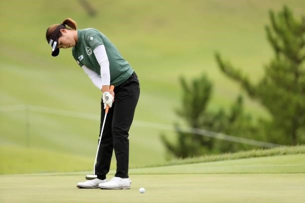 Nozomi Uetake of Japan holes the birdie putt on the 8th green during the second round of the Miyagi TV Cup Dunlop Ladies Open at Rifu Golf Club on...