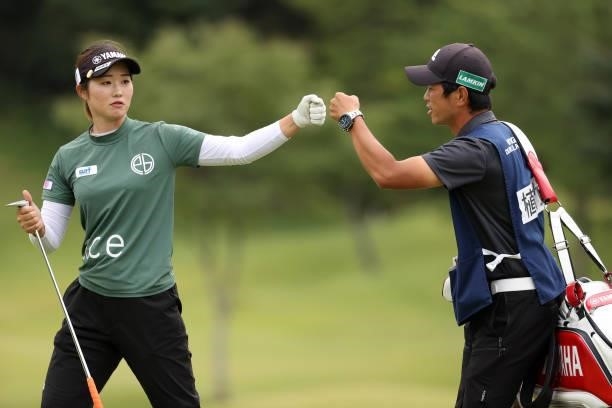 Nozomi Uetake of Japan fist bumps with her caddie after the birdie on the 8th green during the second round of the Miyagi TV Cup Dunlop Ladies Open...