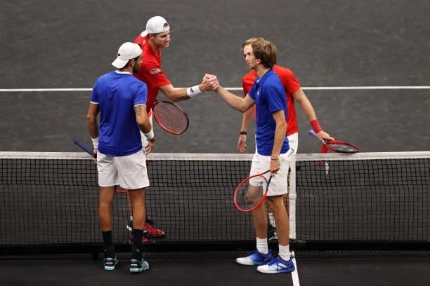 Alexander Zverev and Matteo Berrettini of Team Europe shake hands with John Isner and Denis Shapovalov of Team World after the fourth match during...