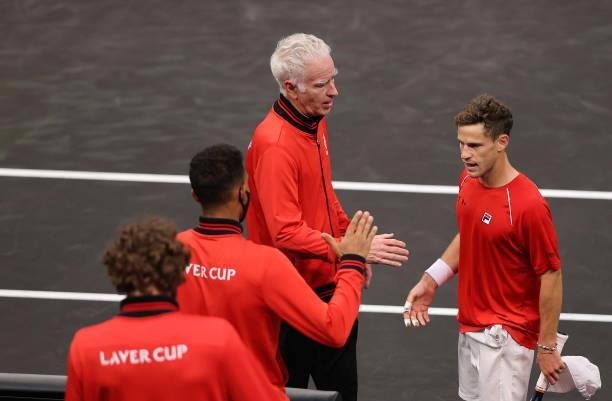 Team World Captain John McEnroe shakes hands with Diego Schwartzman of Team World after the third match during Day 1 of the 2021 Laver Cup at TD...