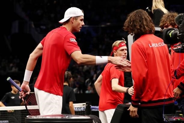 John Isner and Denis Shapovalov of Team World celebrate with teammates after defeating Alexander Zverev and Matteo Berrettini of Team Europe during a...