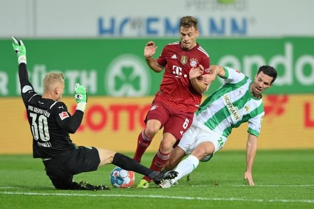 Joshua Kimmich of FC Bayern Muenchen and Sascha Burchert and Nick Viergever of SpVgg Greuther Fuerth compete for the ball during the Bundesliga match...
