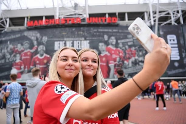 Manchester United fans take a selfie outside the stadium prior to the Premier League match between Manchester United and Aston Villa at Old Trafford...