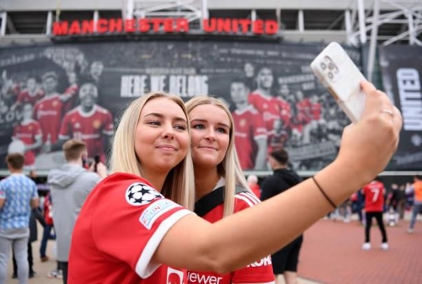 Manchester United fans take a selfie outside the stadium prior to the Premier League match between Manchester United and Aston Villa at Old Trafford...