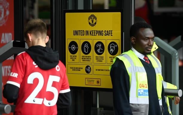 Covid-19 saftey measures sign is seen prior to the Premier League match between Manchester United and Aston Villa at Old Trafford on September 25,...