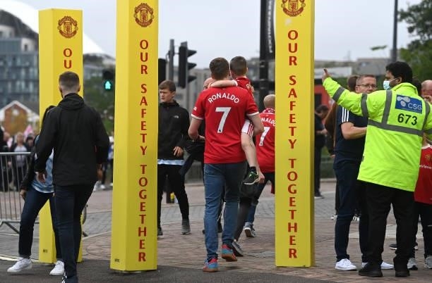Manchester United fans wearing Cristiano Ronaldo of Manchester United shirts arrive at the stadium prior to the Premier League match between...