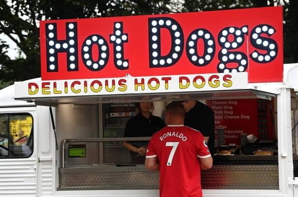Manchester United fan purchases a hotdog prior to the Premier League match between Manchester United and Aston Villa at Old Trafford on September 25,...