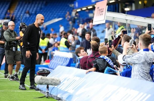 Pep Guardiola, Manager of Manchester City interacts with fans prior to the Premier League match between Chelsea and Manchester City at Stamford...