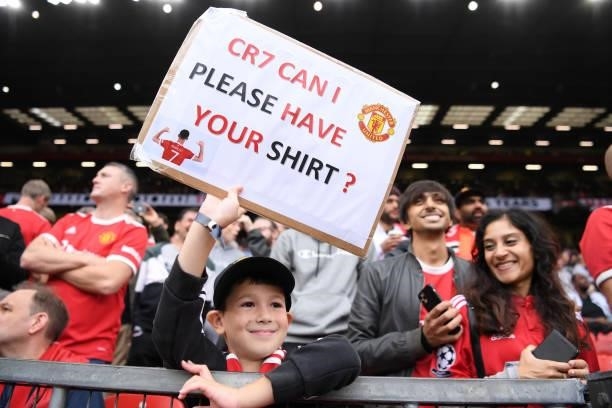 Fan holds up a sign asking Cristiano Ronaldo of Manchester United for his shirt during the Premier League match between Manchester United and Aston...