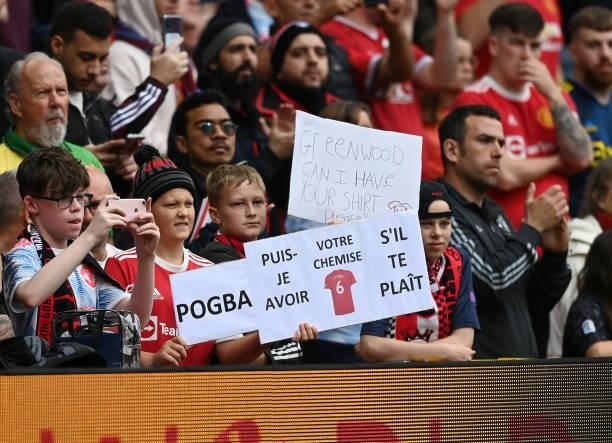 Fan holds up a sign asking Paul Pogba of Manchester United for his shirt during the Premier League match between Manchester United and Aston Villa at...