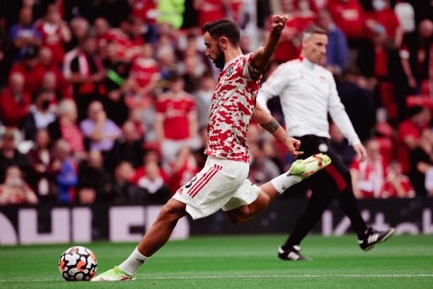 Bruno Fernandes of Manchester United warms up ahead of the Premier League match between Manchester United and Aston Villa at Old Trafford on...