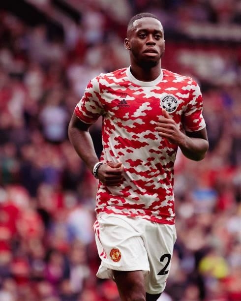 Aaron Wan-Bissaka of Manchester United warms up ahead of the Premier League match between Manchester United and Aston Villa at Old Trafford on...