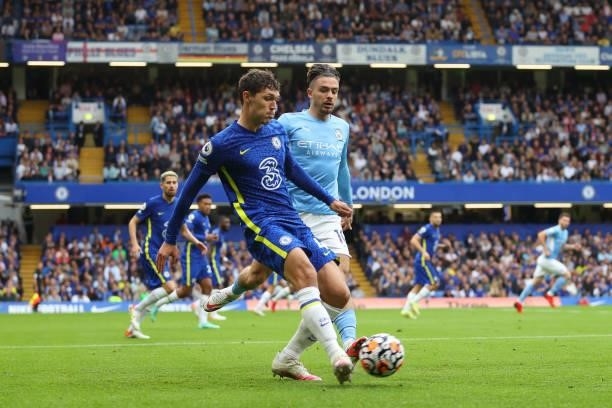 Andreas Christensen of Chelsea passes the ball while under pressure from Jack Grealish of Manchester City during the Premier League match between...