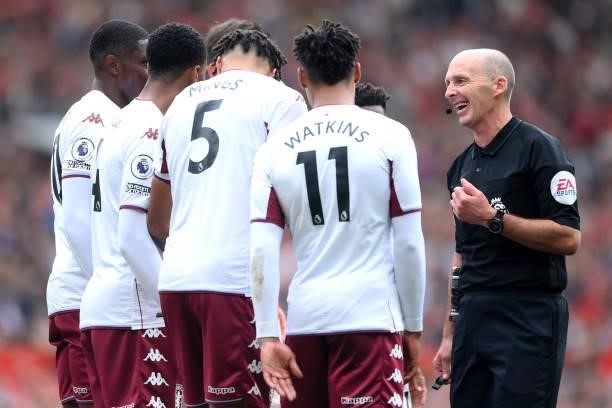 Referee Mike Dean speaks to the wall of Aston V during the Premier League match between Manchester United and Aston Villa at Old Trafford on...