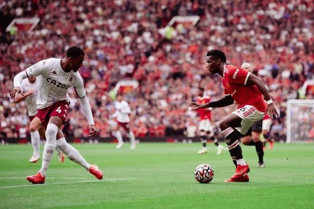 Paul Pogba of Manchester United in action with Ezri Konsa of Aston Villa during the Premier League match between Manchester United and Aston Villa at...