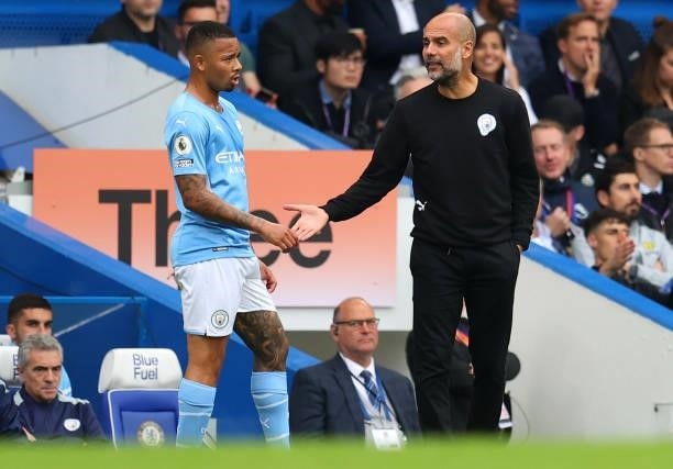 Pep Guardiola, Manager of Manchester City interacts with Gabriel Jesus of Manchester City during the Premier League match between Chelsea and...