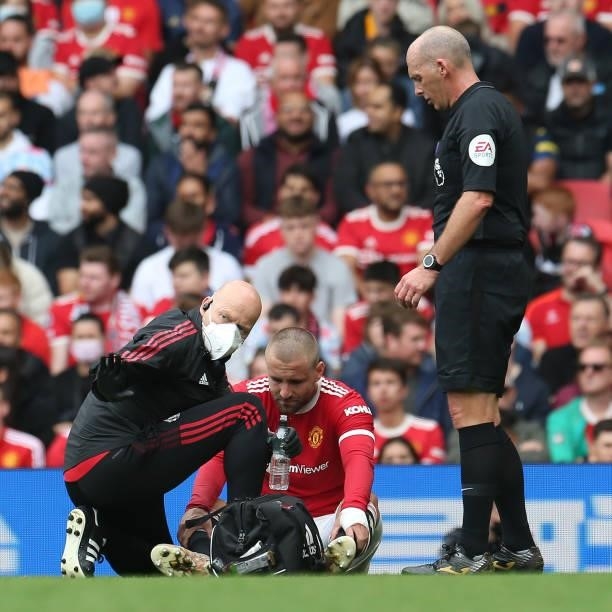 Luke Shaw of Manchester United receives treatment on an injury during the Premier League match between Manchester United and Aston Villa at Old...