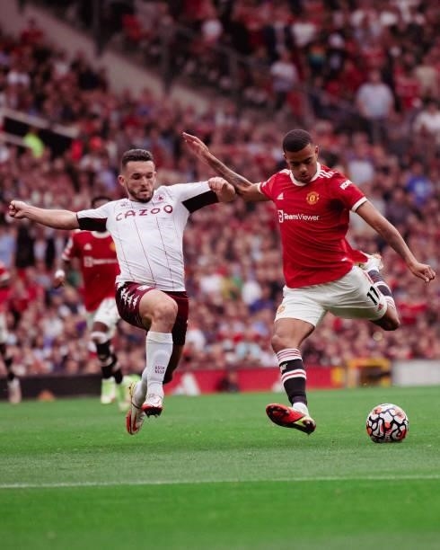 Mason Greenwood of Manchester United in action with John McGinn of Aston Villa during the Premier League match between Manchester United and Aston...