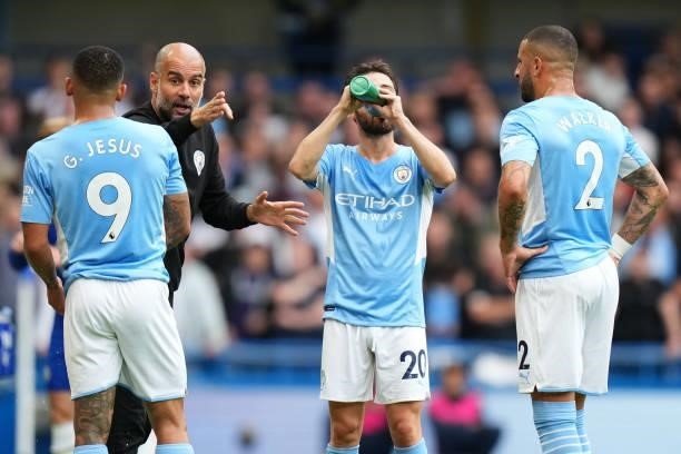 Manchester City manager Pep Guardiola speaks to Kyle Walker and Gabriel Jesus of Manchester City during the Premier League match between Chelsea and...