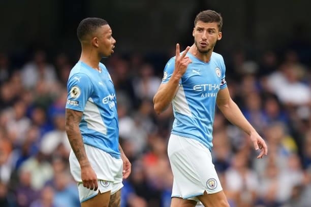 Ruben Dias of Manchester City interacts with Gabriel Jesus of Manchester City during the Premier League match between Chelsea and Manchester City at...