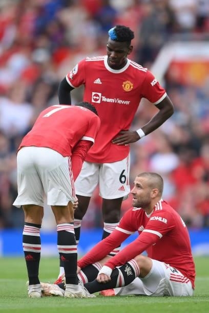Paul Pogba and Cristiano Ronaldo of Manchester United with an injured Luke Shaw during the Premier League match between Manchester United and Aston...