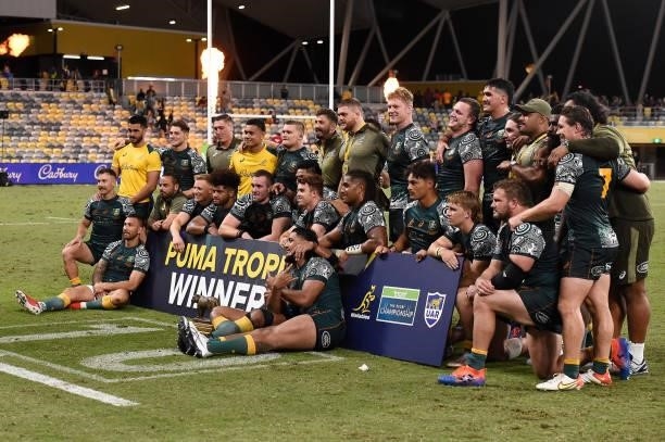 Wallabies players pose with the trophy after The Rugby Championship match between the Australian Wallabies and Argentina Pumas at QCB Stadium on...