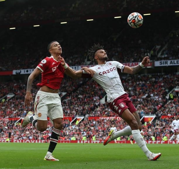 Mason Greenwood of Manchester United in action with Tyrone Mings of Aston Villa during the Premier League match between Manchester United and Aston...