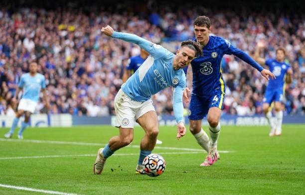 Jack Grealish of Manchester City is pressured by Andreas Christensen of Chelsea during the Premier League match between Chelsea and Manchester City...