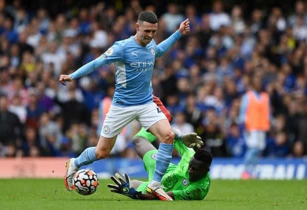 Phil Foden of Manchester City with Edouard Mendy of Chelsea during the Premier League match between Chelsea and Manchester City at Stamford Bridge on...