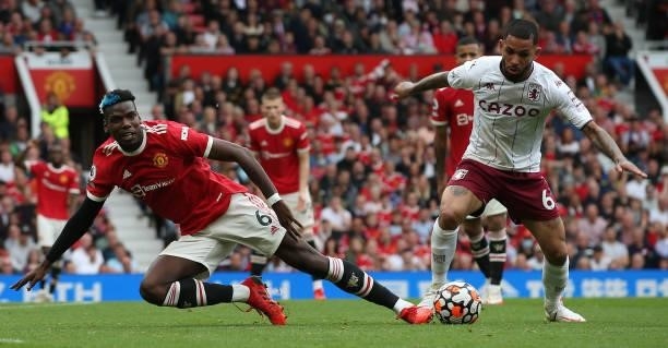 Paul Pogba of Manchester United in action with Douglas Luiz of Aston Villa during the Premier League match between Manchester United and Aston Villa...