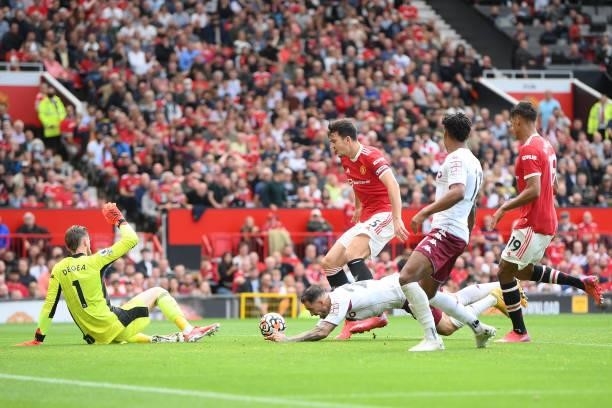 Danny Ings of Aston Villa is fouled inside the box by Harry Maguire of Manchester United during the Premier League match between Manchester United...