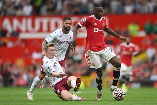 Aaron Wan-Bissaka of Manchester United is tackled by Matt Target of Aston Villa during the Premier League match between Manchester United and Aston...