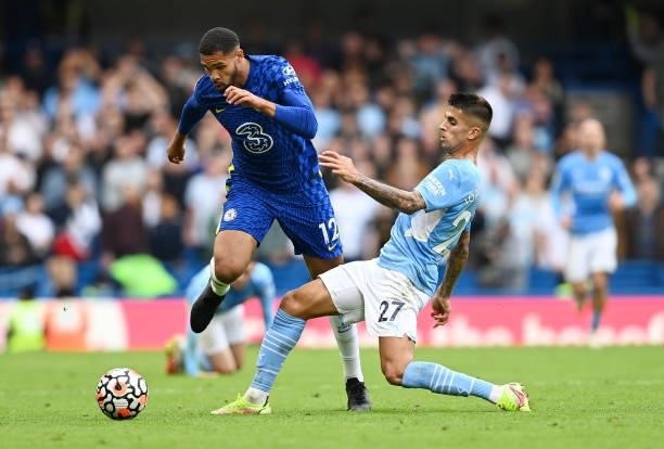 Joao Cancelo of Manchester City tackles Ruben Loftus-Cheek of Chelsea during the Premier League match between Chelsea and Manchester City at Stamford...
