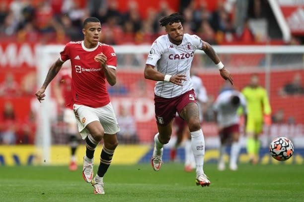 Mason Greenwood of Manchester United battles for possession with Tyrone Mings of Aston Villa during the Premier League match between Manchester...