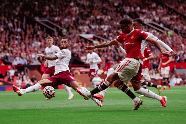 Mason Greenwood of Manchester United in action with Douglas Luiz of Aston Villa during the Premier League match between Manchester United and Aston...