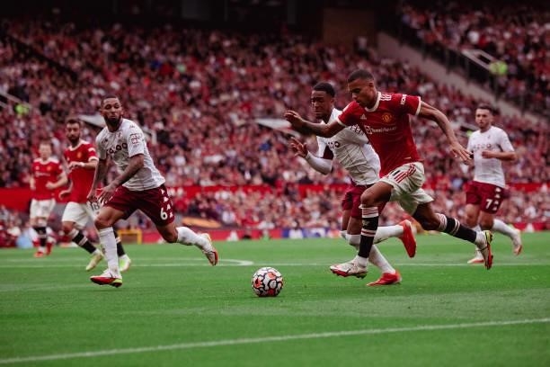 Mason Greenwood of Manchester United in action with Douglas Luiz of Aston Villa during the Premier League match between Manchester United and Aston...