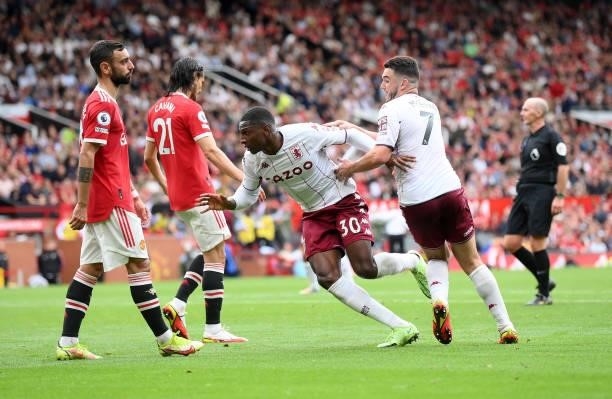 Kortney Hause of Aston Villa celebrates with teammate John McGinn after scoring their team's first goal during the Premier League match between...