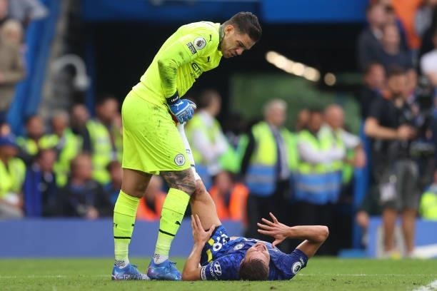 Cesar Azpilicueta of Chelsea is treated for cramp by Ederson of Manchester City during the Premier League match between Chelsea and Manchester City...