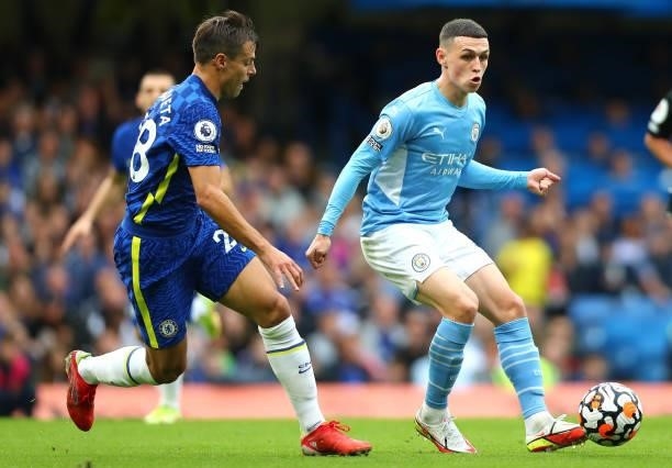 Phil Foden of Manchester City controls the ball under pressure of Cesar Azpilicueta of Chelsea FC during the Premier League match between Chelsea and...