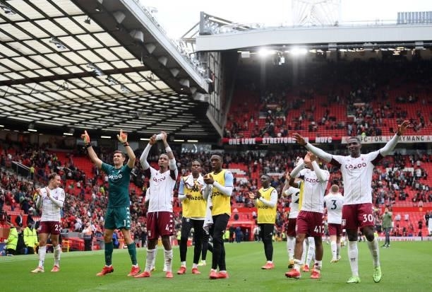 The Aston Villa squad celebrate towards the fans following the Premier League match between Manchester United and Aston Villa at Old Trafford on...